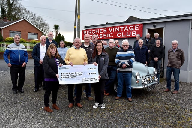 Birches Vintage and Classic Vehicle Club raised an amazing £15,000 for the Northern IrelandChildren's Hospice at a Country Night at the Seagoe Hotel in March. Pictured at the presentation of the cheque are club members and club chairman, John Wilson who presented the cheque to Vivienne Jess, front left, chair of the Banbridge Support Group and Fiona Borkowski, front right, regional fundraiser. PT16-200.