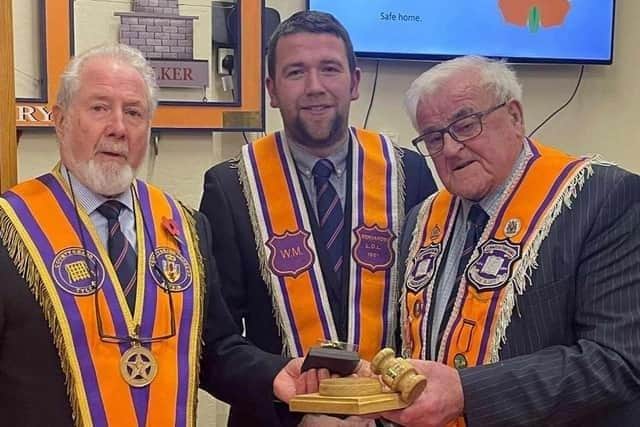Bro Andy McLean (right) receives gifts from Raymond Rodgers, County Grand Tyler, and David Stewart, Worshipful Master Benvarden. Credit News Letter