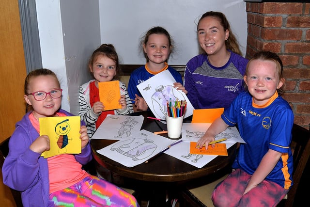 Budding young artists pictured with Amy Stewart, leader, at the Healthy Kidz Summer Camp at Maghery GAC. PT31-205.