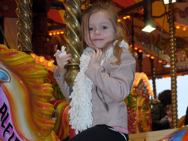 Maddison Maguire gives a wave from the carousel in Whitehead during the Victorian Fair in 2014.