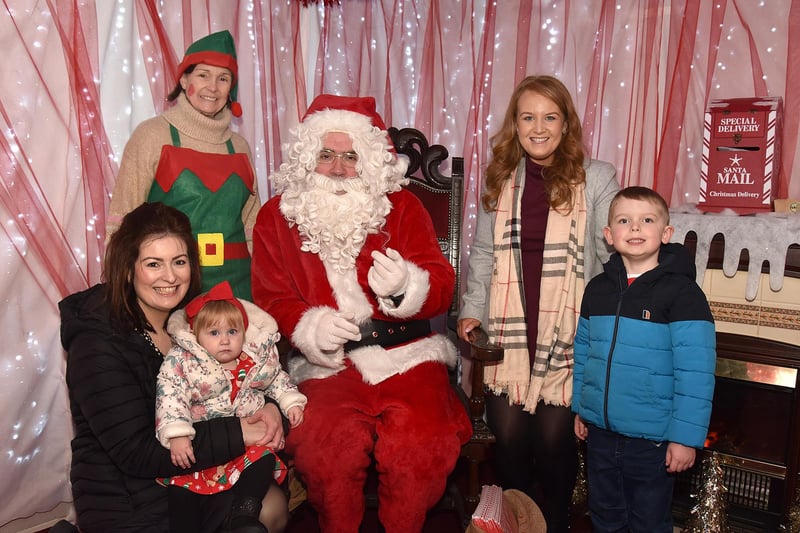 Pictured with Frances the Elf and Santa at his grotto in St Mark's Church tower are from left, Cheryl Simpson, Elsie Madill (1), Christine Hobson and Archie Madill (5). PT50-226.