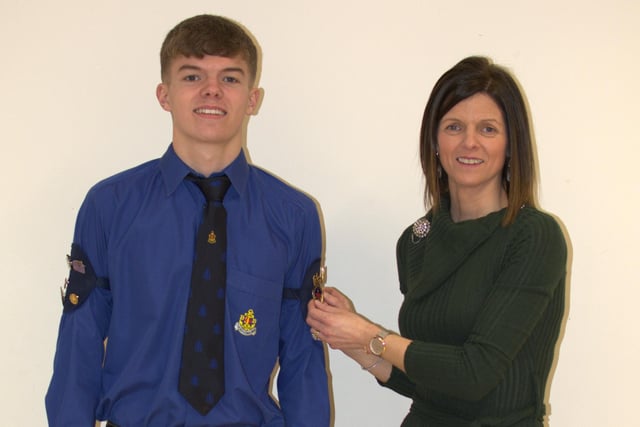 James Reid receiving his Queen's award from his mother who was also the inspecting Officer's wife.