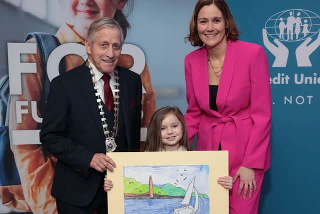 Martin Busch, president of the Irish League of Credit Unions, Morgan Steele of Larne Credit Union, winner of the 7 years and under (AN) category, and MC Grainne McElwain at the 2023 Credit Union Art Competition prize giving in Croke Park. Photo: Robbie Reynolds Photography