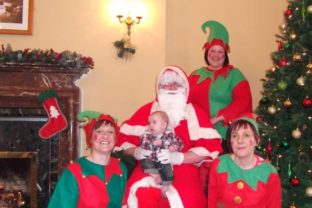 Santa, pictured with his helpers (and one little chappie) at a 'Santa Sunday' event held at the Causeway Hotel in aid of Action Cancer in 2010