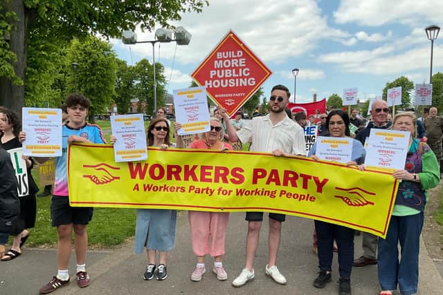 Marching to Belfast City Hall. Tony Dorrian holding the Workers Party placard demanding the building of more Public Housing. While other activists carried placards calling for the end of all evictions now.