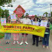 Marching to Belfast City Hall. Tony Dorrian holding the Workers Party placard demanding the building of more Public Housing. While other activists carried placards calling for the end of all evictions now.
