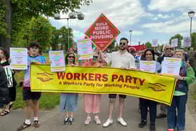 Marching to Belfast City Hall. Tony Dorrian holding the Workers Party placard demanding the building of more Public Housing. While other activists carried placards calling for the end of all evictions now.