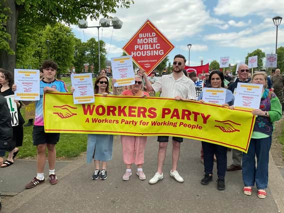 Marching to Belfast City Hall. Tony Dorrian holding the Workers Party placard demanding the building of more Public Housing. While other activists carried placards calling for the end of all evictions now.