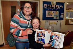 Showing off her photo record of her time at the playgroup is past pupil Sophie Elliott and her mum, Wendy. PT48-235.