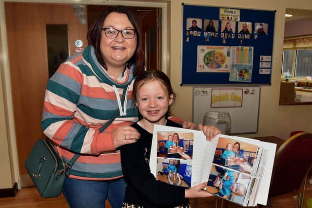 Showing off her photo record of her time at the playgroup is past pupil Sophie Elliott and her mum, Wendy. PT48-235.