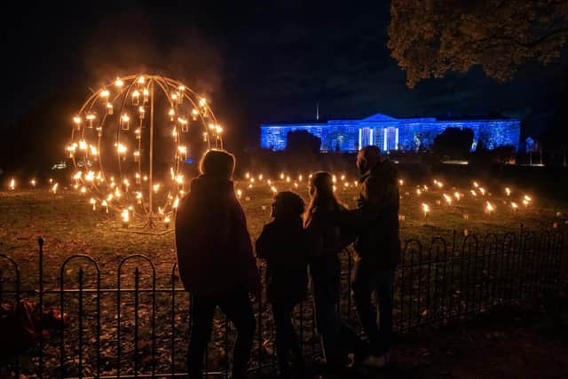 The striking Fire Garden, made up of 140 candles, in front of the illuminated Hillsborough Castle