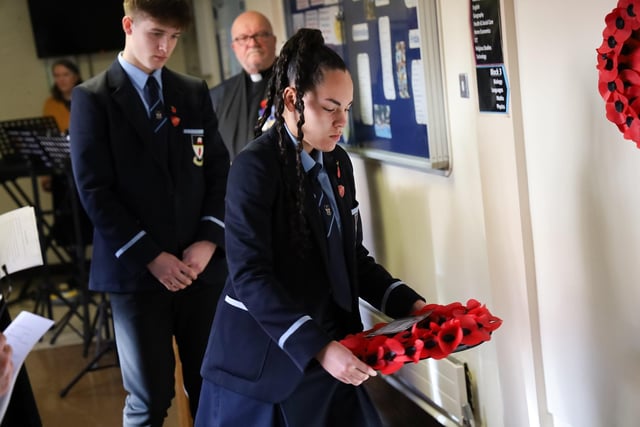 Head Girl and Head Boy lay wreaths at the school's memorial plaque to fallen pupils.