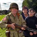 'GI' Gerry Coleman from the Wartime Living History Group pictured at the WWII Fun Day at Brownlow House, Lurgan, on Saturday with Yvonne Hegarty, Kian O'Hagan (11) and Seamus Macrory. LM39-200.