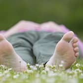 Woman enjoying nature on a summer day in a field of daisies. © Pete Cairns / naturepl.com / WWF