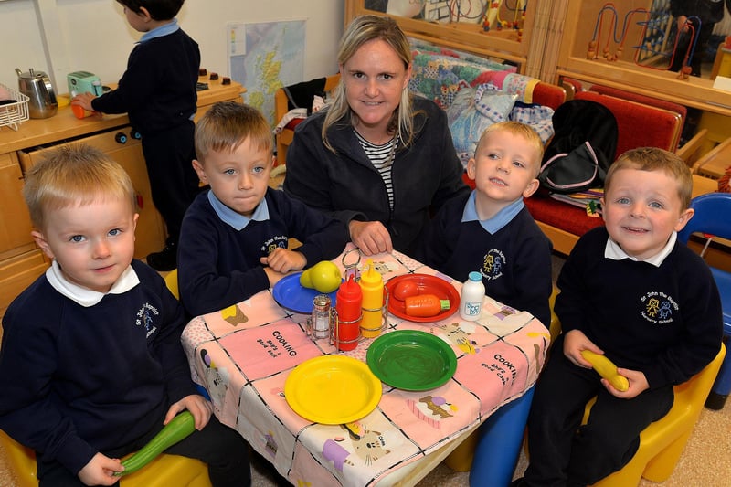 St John the Baptist Nursery School nursery assistant, Bronagh Fullen joins in play with some of her pupils. PT41-309.