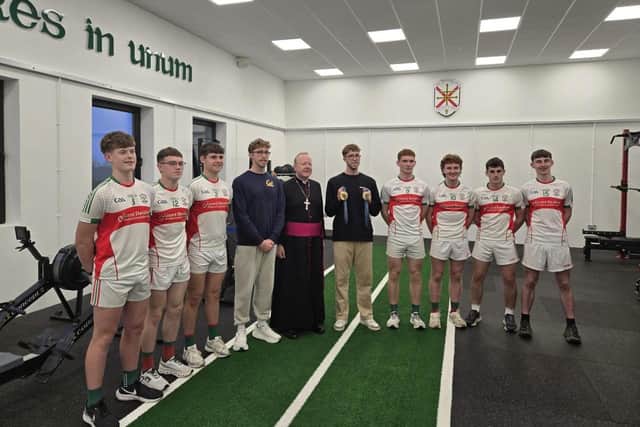 Archbishop Eamon Martin with Daniel and Nathan Wiffen and members of the school GAA team in the new facility.