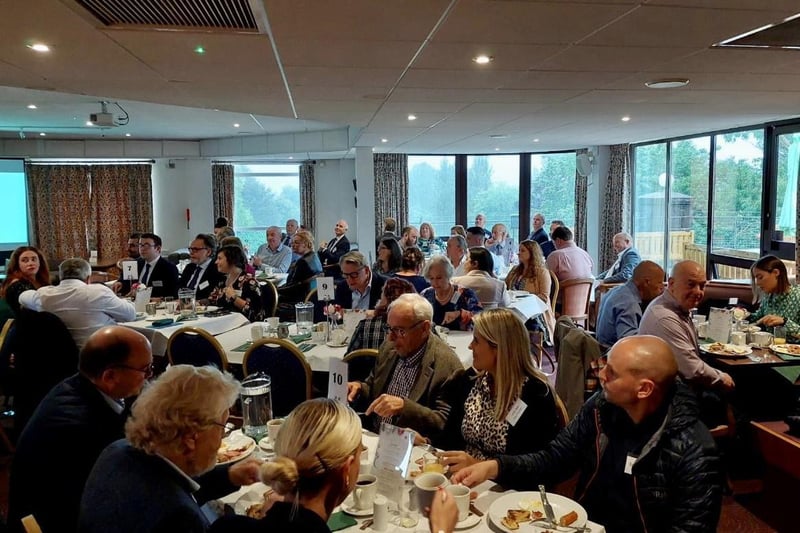 Attendees enjoying the golf club breakfast before the presentations began.