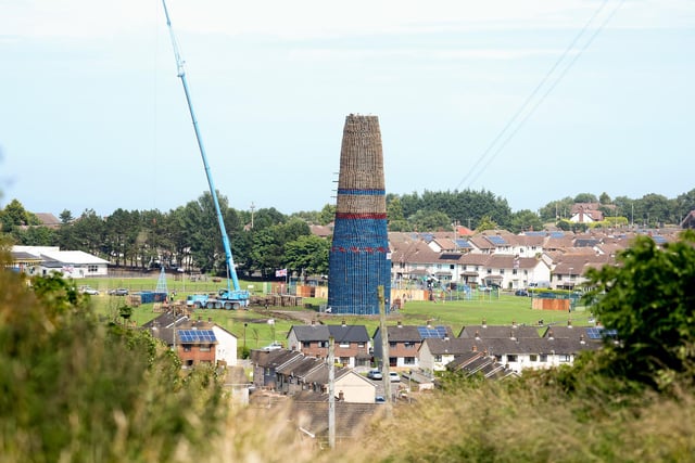 The Craigyhill bonfire in Larne is topped off ahead of this year’s 11th night celebrations.  Bonfire builders use a telescopic crane to reach the top.