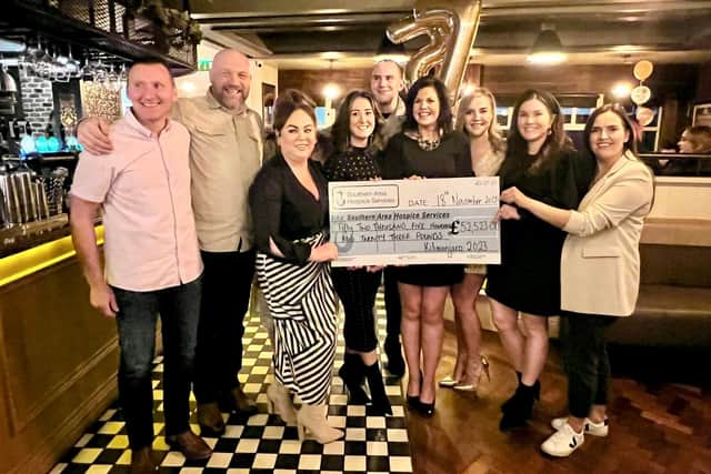 Presenting a cheque for £52,523 to the Southern Area Hospice were Adrian McAnarney (left) with hiking friends Johnny Simpson, Emma Mullen, Andrea Ferris, Leanne Ward, Lisa Gribben, Sarah-Jane McGeown, Mairead McNeice, Karen Keenan and George O`Hara.