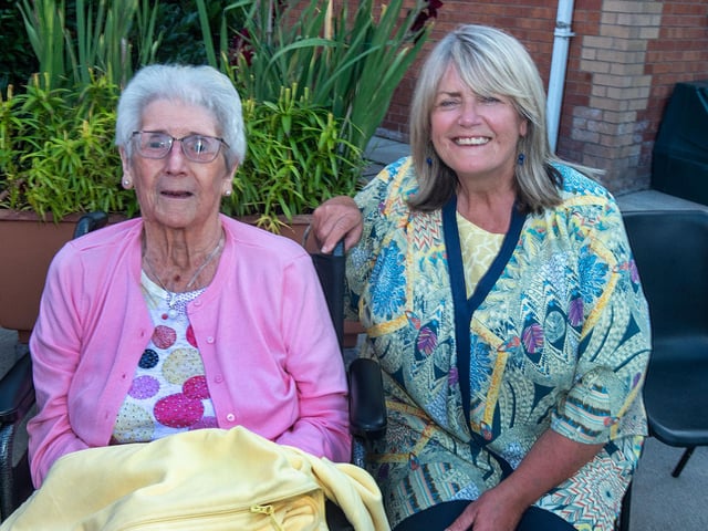 Enjoying the atmosphere at the vintage vehicle rally are Mahon Hall resident Sally Adamson and her daughter, Wendy Lappin.