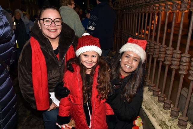 Happy faces at the Thomas Street Methodist Church Christmas lights switch on. Included are from left, Deborah McAteer, Mia McAteer (5) and Adrianna Thompson. PT50-202.