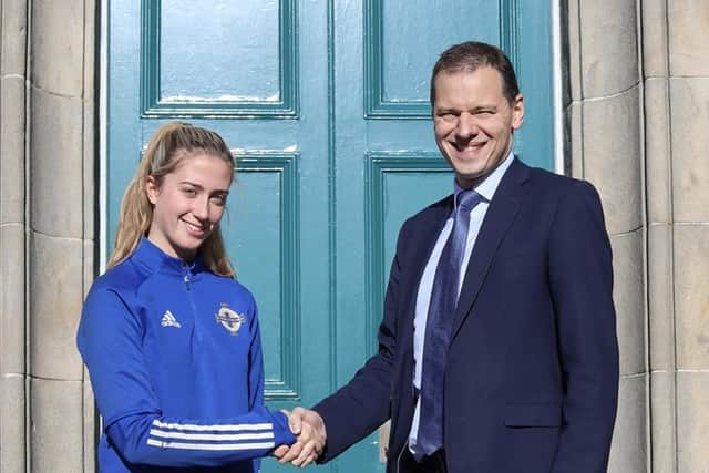 Ellie is congratulated on her success by her school principal Mr Robin McLoughlin