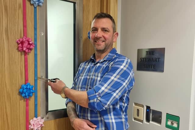 Connor Stewart cuts the ribbon to officially open the Stewart Suite at Hollybank short break unit. Credit: Supplied