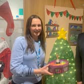Warren House Consultant Clinical Psychologist Anna Shepherd was crowned the winner at the annual Christmas Door Competition and is awarded the all-important trophy and some festive treats by South Eastern Health Trust Chairman Jonathan Patton. Pic credit: SEHSCT