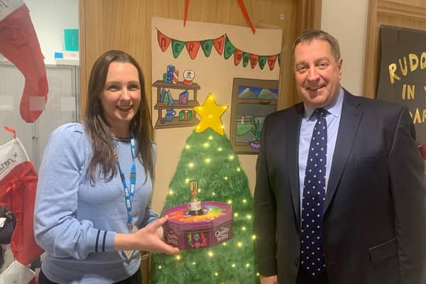 Warren House Consultant Clinical Psychologist Anna Shepherd was crowned the winner at the annual Christmas Door Competition and is awarded the all-important trophy and some festive treats by South Eastern Health Trust Chairman Jonathan Patton. Pic credit: SEHSCT