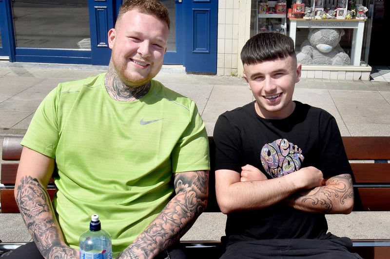 Taking a well earned break in the sunshine are two barbers from the Porter Green Barbers in Market Street, Adam McBroom, left, and Jack Sommersby. PT22-240.