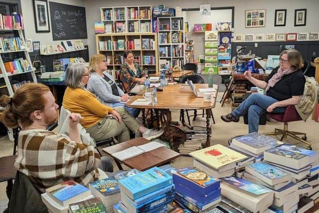 The Secret Bookshelf's Jo Zebedee (right) in discussion at the shop.  Photo: Nina Couser