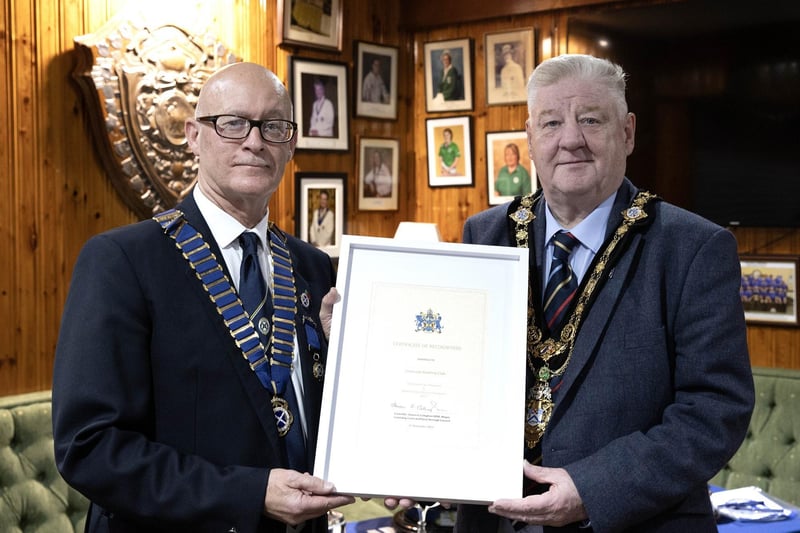 Mayor of Causeway Coast and Glens, Councillor Steven Callaghan presenting Limavady Recreation Club President Wilfie Moore with a certification from his office commemorating their historic win in the Irish Senior Cup.