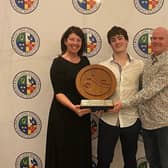 Jacqueline McClelland presents the Ted Keenan Ulster Swimmer of the Year Award to record breaking Newry Junior Daniel Smyth, with coach Keith Garry.