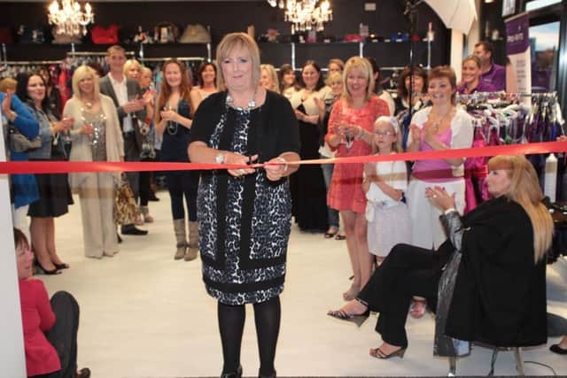 Perfect Night proprietor Bernie O'Neill cutting the ribbon to open her new shop 'Perfect Day' in William St, Lurgan. INLM3511-922dmg