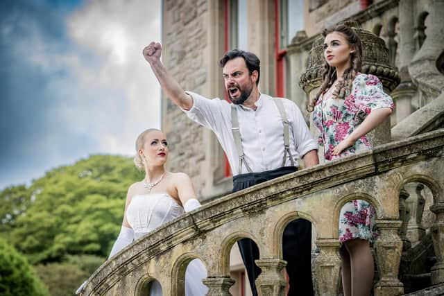 Karen Hawthorne as Eva Peron aka Evita, David McCrossan as Everyman and Caroline McMichael as young Eva Duarte. Pic credit: Ulster Operatic Society