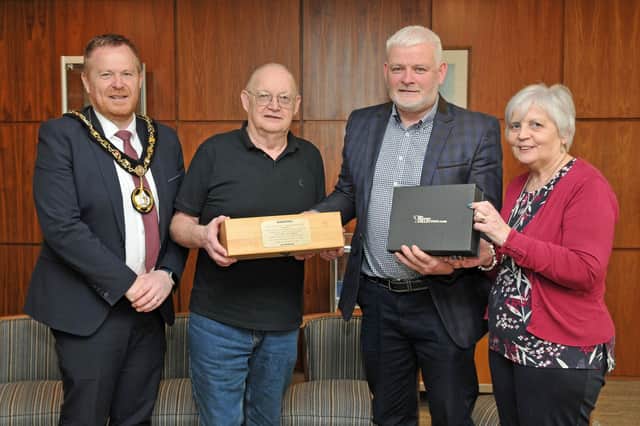 Sergeant Alwyn Peters receives gifts to mark his retirement from the PSNI Neighbourhood Team in the Craigavon area, from, Denis Loney, Enniskeen Community Group and Andreana Cohoun, Drumgor Heights Community. Looking on is Lord Mayor, Councillor Paul Greenfield.