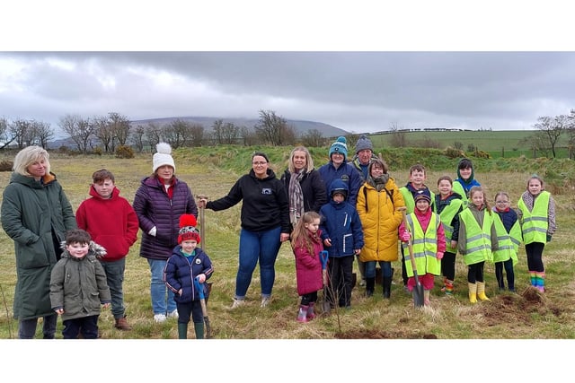 Ruth McNeill and Gerry Burns from Armoy Community Association alongside children from Armoy Primary school, St Olcan’s Primary School and Armoy Cross Community Playgroup, planting native trees in Limepark in Armoy.