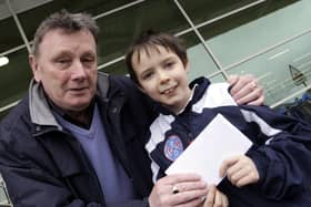 WALK THIS WAY.,,Johnny McCurdy, President of Ballymoney Utd Youth Academy, pictured in 2009, handing over a JJB Sports gift voucher to young Adrian Gilmore, who was the top fundraiser during a sponsored walk to raise funds for the Academy.