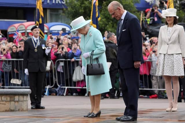 COLERAINE, NORTHERN IRELAND - JUNE 25: Queen Elizabeth II and Prince Philip, Duke of Edinburgh pay their respects at the cenotaph in Coleraine during the launching of World War One commemorations, on the third and final day of the Queen's visit to Northern Ireland, on June 25, in Coleraine, Northern Ireland. (Photo by Paul Faith - WPA Pool/Getty Images)