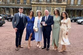 Former Lurgan College headmaster Trevor Robinson at Buckingham Palace where he received an OBE from Princess Anne. He was accompanied by his wife Julie and his children Charlotte, Matthew, Annie and Ellie.