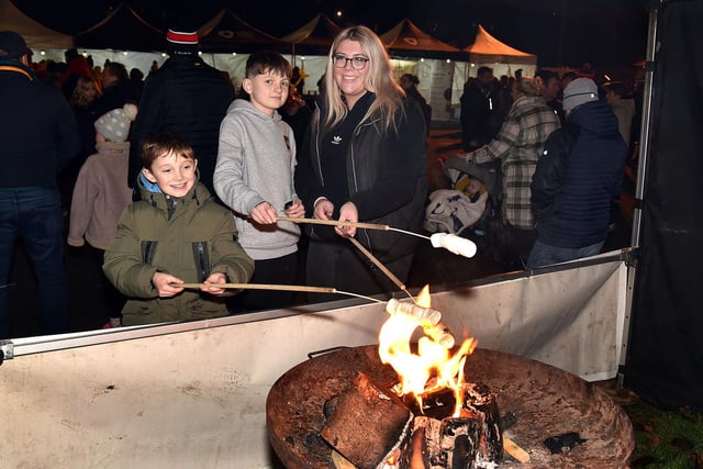 Toasting marsmallows at the Richhill Christmas lights switch on are from left, Cain Black (9), Ewan Black and Mia Gray. PT49-249.