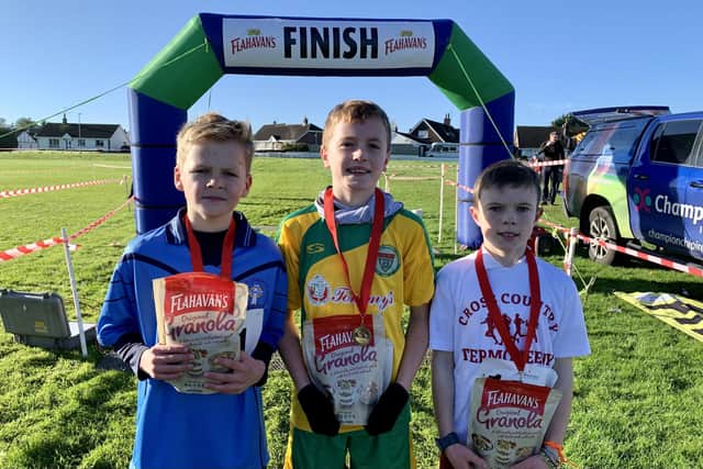Ronan Smith in 2nd place, Davin Gallagher in 1st place and Daniel Boyle in 3rd place at the first round of the 2023-2023 Flahavan’s Athletics NI Primary School Cross Country League. Credit Morrow Communications