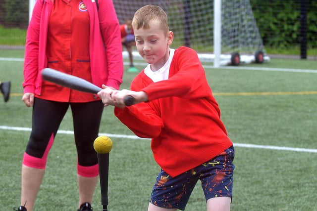 One of the Presentation Primary School pupils having a go at baseball during the joint fun day with Hart Memorial Primary School in Portadown People's Park. PT24-204.