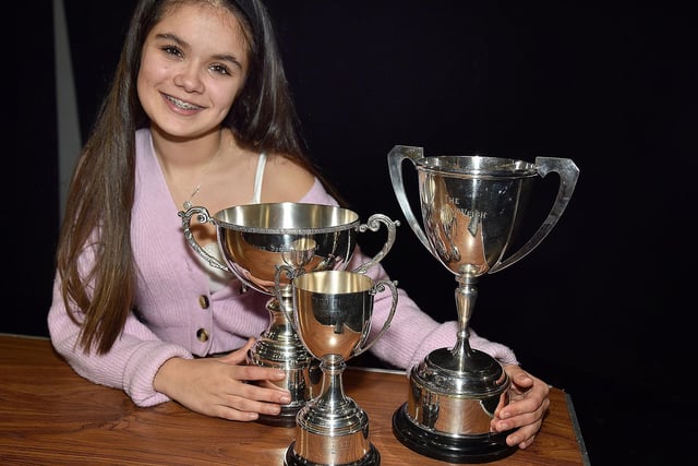 Sophie Matthews pictured with the three overall award trophies won at Portadown Speech Festival's final night. PT10-235.
