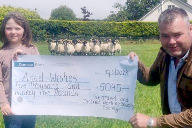 John McFadden presents a cheque for £5095 (proceeds of the at the Glenravel & District Working Sheepdog Society 75th anniversary trials at McFadden's Farm) to Cora McKeown of the Angel Wishes charity.