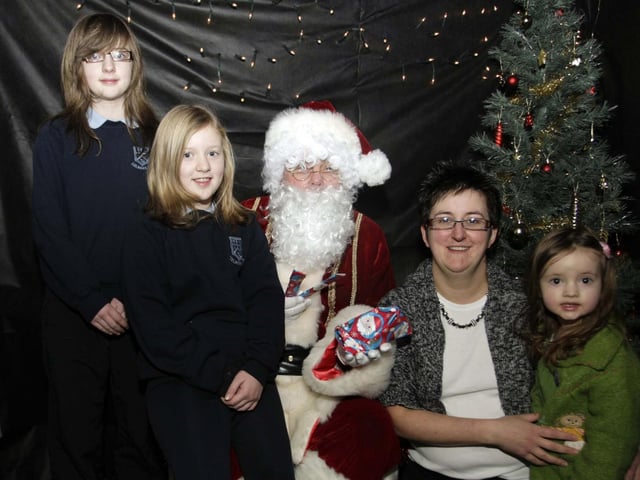 Getting to meet Santa at Lislagan PS in 2008 are kids, Hollie, Leah and Kiera with their mum, Donna McIlveen.