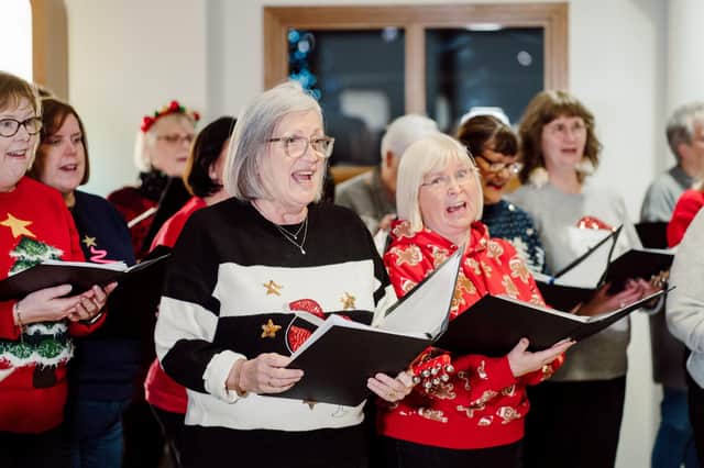 The Courtyard Community Choir with some festive tunes at the event reception.