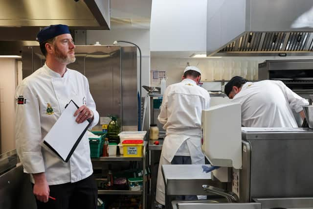 One of the competition judges keeps an eye on things in the kitchen.