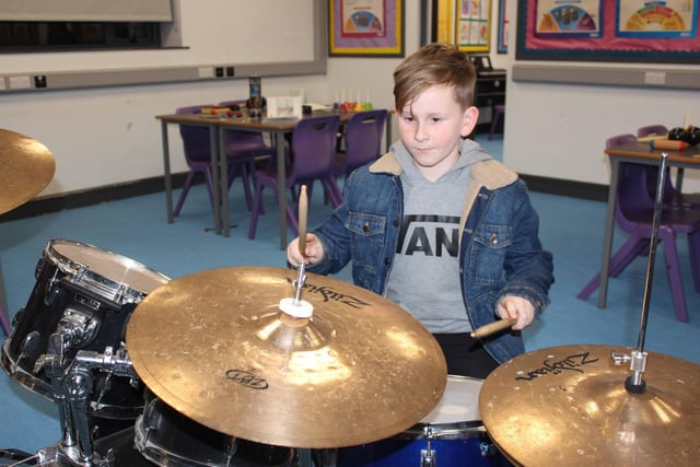 Vinnie from Ballymacrickett PS giving the drums a go at the St Patrick's Academy open day