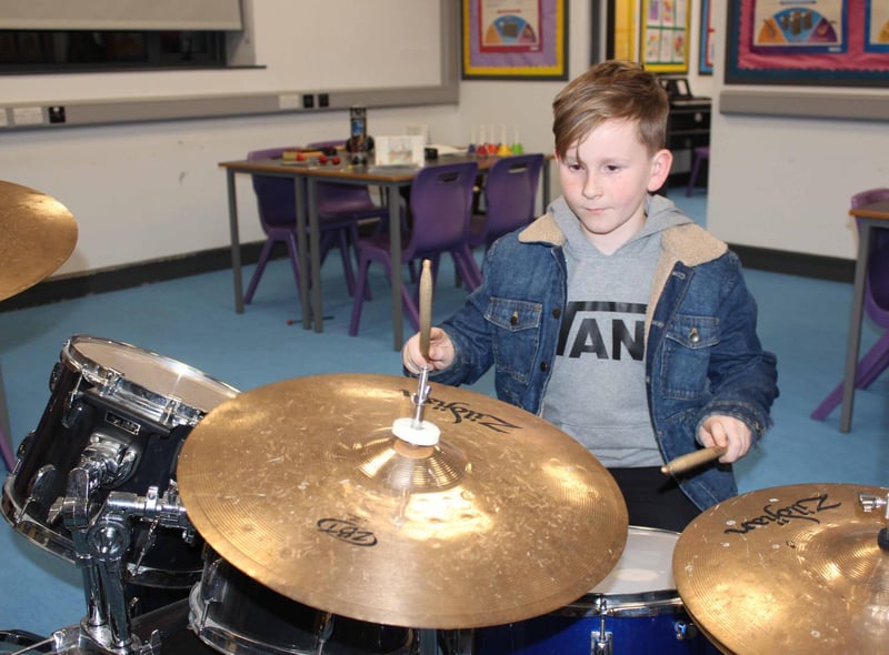 Vinnie from Ballymacrickett PS giving the drums a go at the St Patrick's Academy open day
